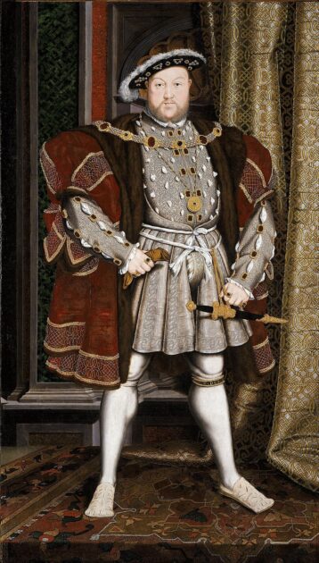Royal portrait of King Henry VIII, who has one of the grossest and most odorous royal deaths in history. He stands, belly protruding from his find outfit, holding a knife in one hand and with a look of disdain on his pudgy face.